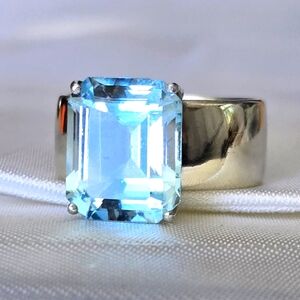 Emerald Cut Sky Blue Topaz On Wide Sterling Silver Band (small chip on topaz)